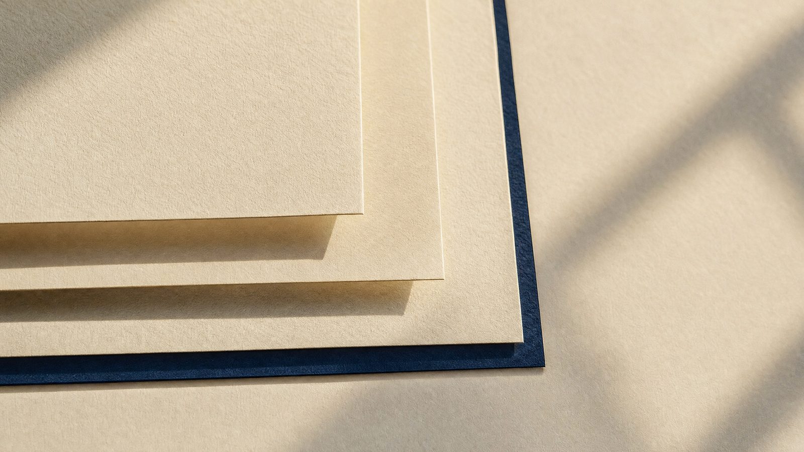 Cream paper sheets stacked in exact register, a study in brand consistency